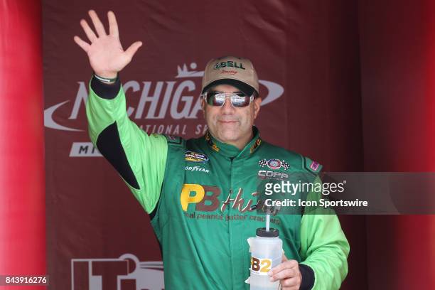 Mike Senica , driver of the unsponsored Chevrolet, greets fans during the pre-race ceremonies of the Camping World Truck Series LTi Printing 200 race...