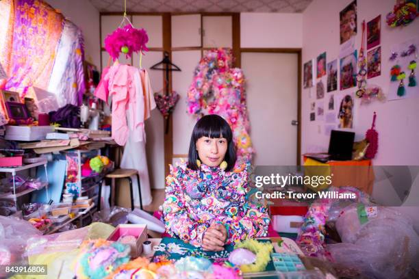 a female contemporary artist working in her studio creating art with textiles - spinner stock-fotos und bilder