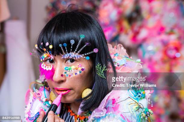 a female contemporary artist dressing up in colorful fashion - acessórios de moda imagens e fotografias de stock