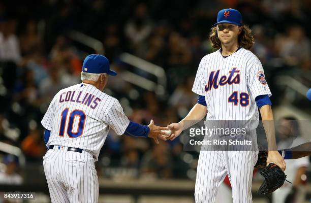 Pitcher Jacob deGrom of the New York Mets hands the ball to manager Terry Collins during the fourth inning against the Philadelphia Phillies during a...