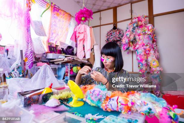 a female textile artist working in her colorful studio - sequin blouse stock pictures, royalty-free photos & images