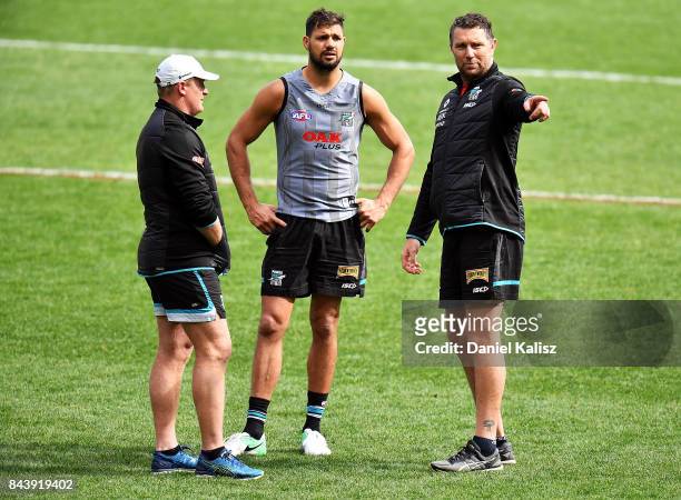 Michael Voss Midfield Manager of the Power, Patrick Ryder of the Power and Brendon Lade Forwards and Rucks coach of the Power chat during a Port...
