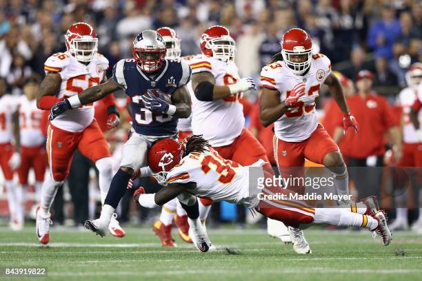 Ron Parker of the Kansas City Chiefs attempts to tackle Mike Gillislee of the New England Patriots during the first half of their game at Gillette...