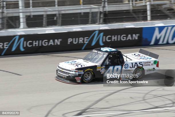 Wendell Chavous , driver of the JAS Expedited Trucking, LLC Chevrolet, races during the Camping World Truck Series LTi Printing 200 race on August...