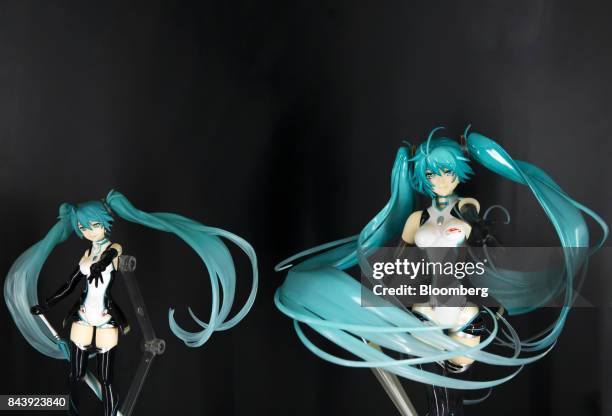 Figures of Hatsune Miku, a virtual pop star and the voice behind Crypton Future Media Inc.'s vocal synthesizer software, stand on display during the...