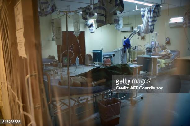 In this photograph taken on August 28, 2017 a wounded Afghan National Army soldier recovers in a ward after receiving treatment in an Afghan military...