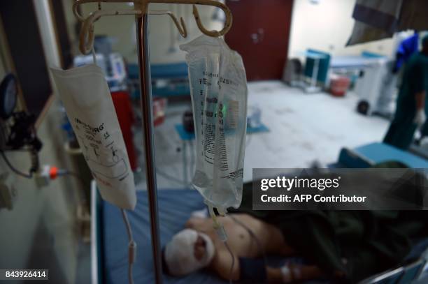 In this photograph taken on August 28, 2017 a wounded Afghan National Army soldier recovers in a ward after receiving treatment in an Afghan military...