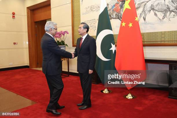 Chinese Foreign Minister Wang Yi shakes hands with Pakistan Foreign Minister Khawaja Muhammad Asif at Diaoyutai State Guesthouse on September 8, 2017...