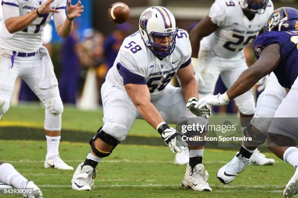 Offensive lineman Gerren Butler of the James Madison Dukes prepares to block a East Carolina Pirates lineman during a game between the James Madison...