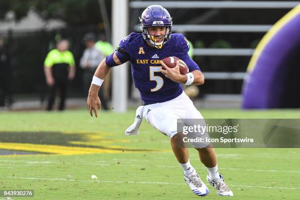 Quarterback Gardner Minshew of the East Carolina Pirates scrambles with the ball during a game between the James Madison Dukes and the East Carolina...