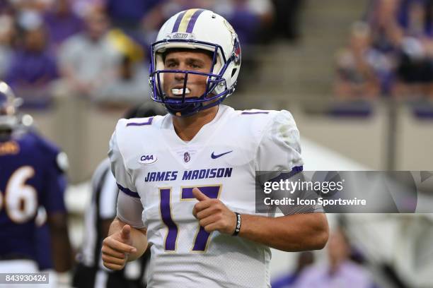 Quarterback Bryan Schor of the James Madison Dukesjogs off the field during a game between the James Madison Dukes and the East Carolina Pirates on...