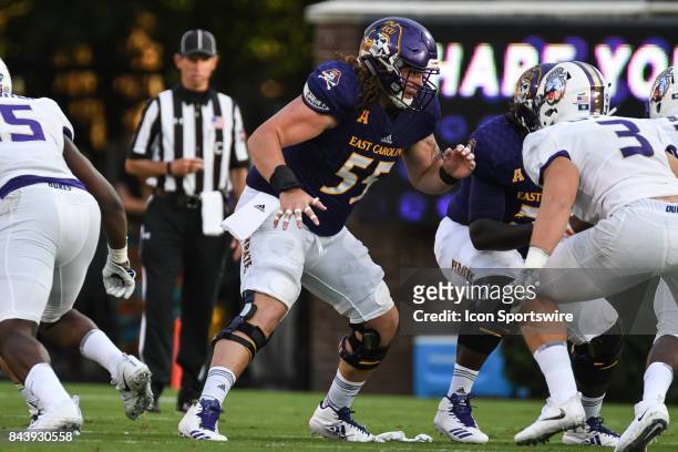 Offensive lineman Garrett McGhin of the East Carolina Pirates looks for a block during a game between the James Madison Dukes and the East Carolina...