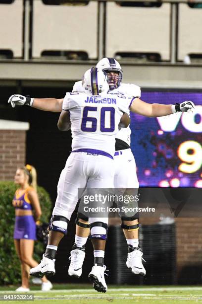 Offensive lineman Jahee Jackson of the James Madison Dukes celebrates with a teammate after a touchdown during a game between the James Madison Dukes...