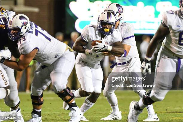Running back Trai Sharp of the James Madison Dukes takes a handoff during a game between the James Madison Dukes and the East Carolina Pirates on...