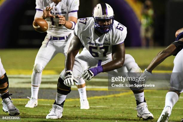 Offensive lineman Zaire Bethea of the James Madison Dukes looks for a block during a game between the James Madison Dukes and the East Carolina...