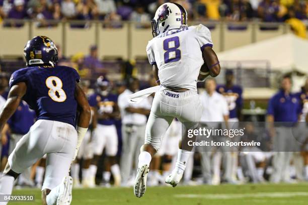 Wide receiver Tahj Deans of the East Carolina Pirates catches a pass during a game between the James Madison Dukes and the East Carolina Pirates on...
