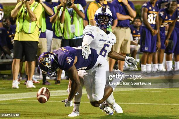 Cornerback Jimmy Moreland of the James Madison Dukes is called for pass interference against wide receiver Jimmy Williams of the East Carolina...