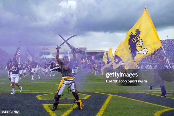 East Carolina Pirates players and cheerleaders take the field during a game between the James Madison Dukes and the East Carolina Pirates on...