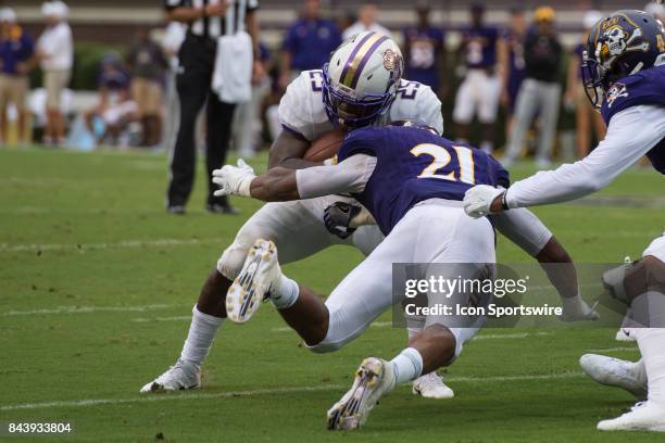 Linebacker Ray Tillman of the East Carolina Pirates tackles running back Cardon Johnson of the James Madison Dukes during a game between the James...