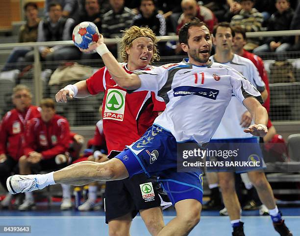 Serbia's Alem Toskic attempts to score as he vies with Norway's defence during their Group D match at the Men's Handball World Championship on...