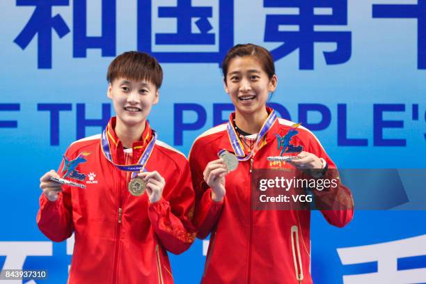 Chen Yufei and Wang Shixian pose with their medals after the Women's singles badminton final match during the 13th Chinese National Games on...