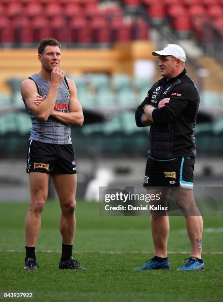 Brad Ebert of the Power and Michael Voss Midfield Manager of the Power chat during a Port Adelaide Power AFL training session at Adelaide Oval on...