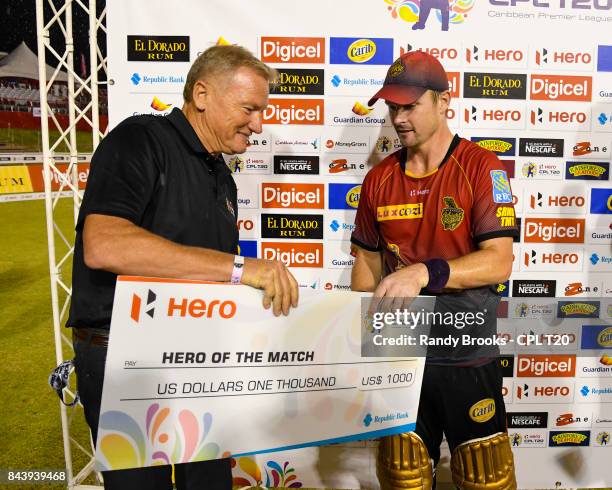 In this handout image provided by CPL T20, Colin Munro of Trinbago Knight Riders receives the man of the match cheque from Richard Bevan CPL Chairman...