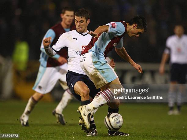 David Bentley of Tottenham Hotspur tangles with Stephen Jordan of Burnley during the Carling Cup Semi Final 2nd Leg match between Burnley and...