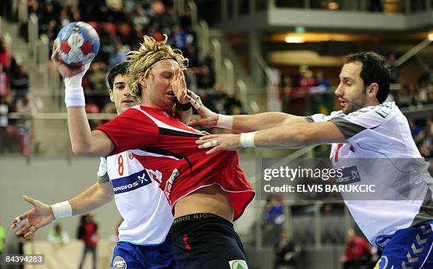 Serbia's Nenad Vuckovic and Alem Toskic attempt to stop Norway's Erlend Mamelund during their Group D Men's Handball World Championship match on...
