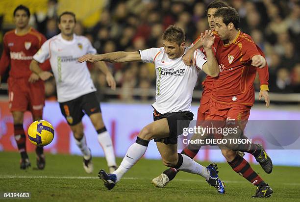 Valencia's Joaquin vies for the ball with Sevilla's Francisco Navarro during their Spanish king cup football match at Mestalla Stadium in Valencia,...