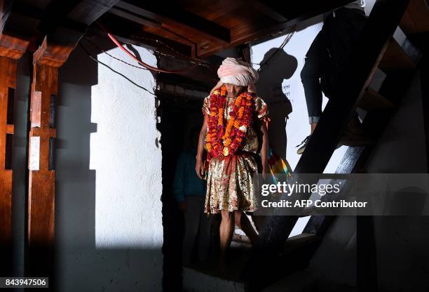 This photograph taken on September 3, 2017 shows Nepali Lakhe dancer Laxman Ranjit arrives to put on his costume before performing the "Lakhe" dance...