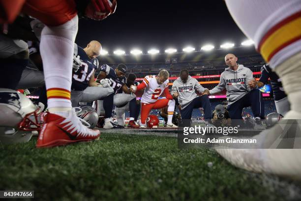 New England Patriots and Kansas City Chiefs players pray after the Chiefs defeated the Patriots 42-27 at Gillette Stadium on September 7, 2017 in...