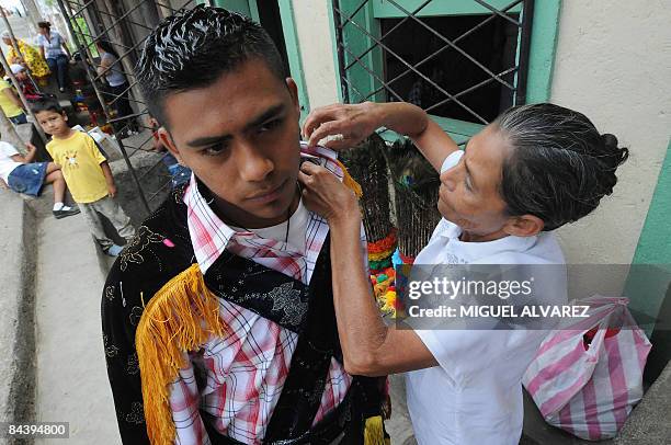 By Julia Rios - A boy is helped to get dressed on January 20 during the festivity of San Sebastian in Diriamba, province of Carazo, some 50 km south...