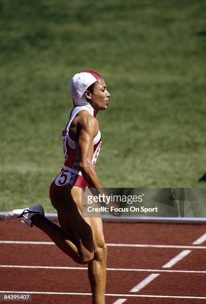 Florence Griffith Joyner of the USA competes during the 100M race during the 1988 Summer Olympic Games at the Seoul Olympic Stadium in Seoul, South...