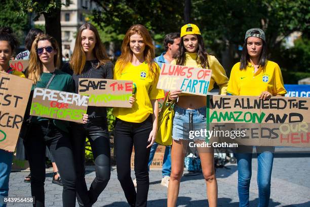 Models Sofia Resing and Wanessa Milhomem are seen during a protest to save the Amazon rainforest in Union Square on September 7, 2017 in New York...