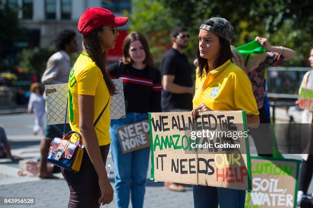 Models Lais Ribeiro and Wanessa Milhomem are seen during a protest to save the Amazon rainforest in Union Square on September 7, 2017 in New York...