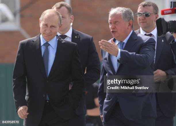President Vladimir Putin of Russia chats with Igor Sechin, President of Rosneft during a visit to the Zvezda Shipyard on September 8, 2017 in Bolshoy...