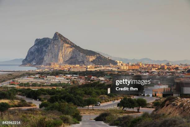 gibraltar rock and la linea de la conception - morocco (africa) in the background (spain and gibraltar/ uk) - la linea de conception stock pictures, royalty-free photos & images