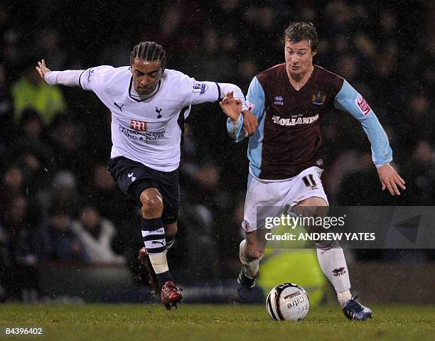 Burnley's English midfielder Wade Elliott vies with Tottenham Hotspur's Cameroonian defender Benoît Assou-Ekotto during the Carling Cup semi final...