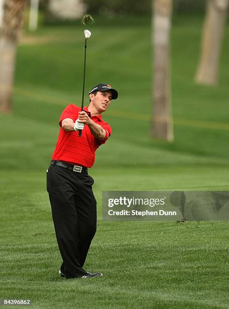 Mike Weir of Canada hits from the fairway on the eighth hole on the Palmer Private Course at PGA West during the first round of the Bob Hope Chrysler...