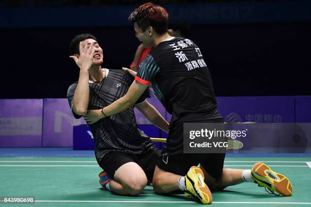 Wang Yiilv and Liu Cheng celebrate after winning the Men's doubles badminton final match against Hong Wei and Chai Biao during the 13th Chinese...