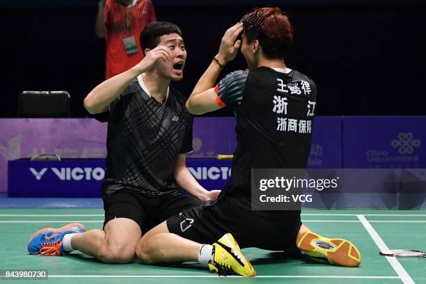 Wang Yiilv and Liu Cheng celebrate after winning the Men's doubles badminton final match against Hong Wei and Chai Biao during the 13th Chinese...