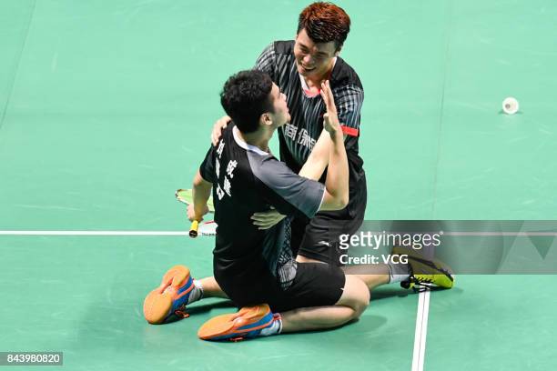 Wang Yiilv and Liu Cheng celebrate after winning the Men's doubles badminton final match against Hong Wei and Chai Biao during the 13th Chinese...