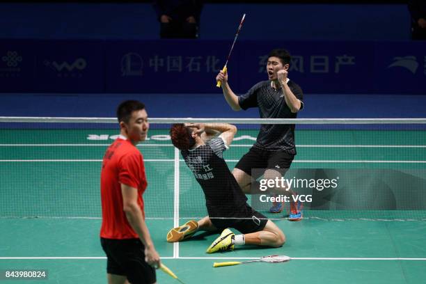 Wang Yiilv and Liu Cheng celebrate after winning the Men's doubles badminton final match against Hong Wei and Chai Biao during the 13th Chinese...