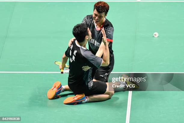 Wang Yiilv and Liu Cheng celebrate after winning the Men's doubles badminton final match against Hong Wei and Chai Biao during the 13th Chinese...