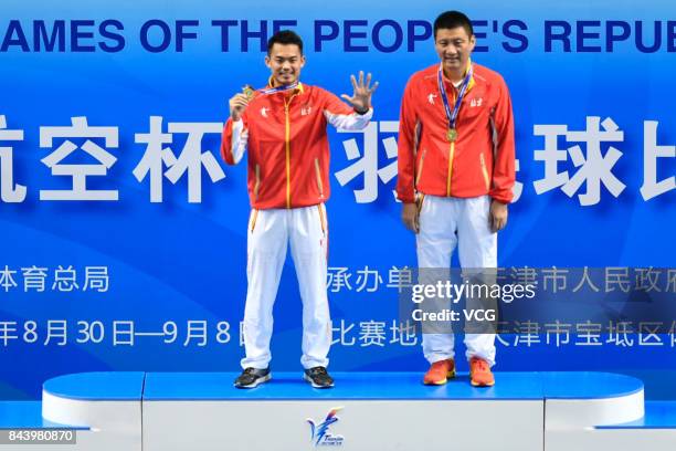 Lin Dan stands on the podium after winning the Men's singles badminton final match against Shi Yuqi on day twelve of the 13th Chinese National Games...