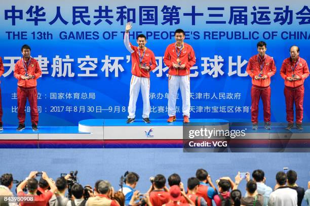 Lin Dan stands on the podium after winning the Men's singles badminton final match against Shi Yuqi on day twelve of the 13th Chinese National Games...