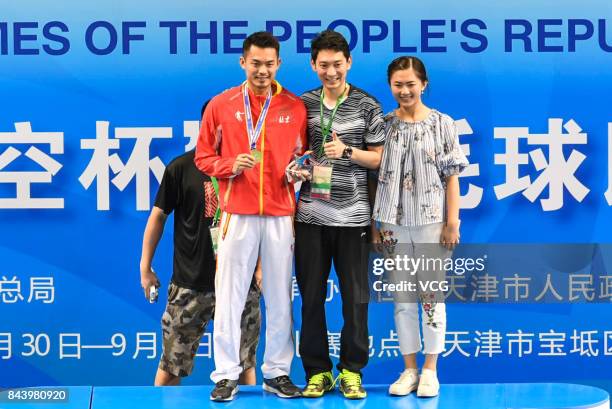 Lin Dan stands on the podium after winning the Men's singles badminton final match against Shi Yuqi on day twelve of the 13th Chinese National Games...