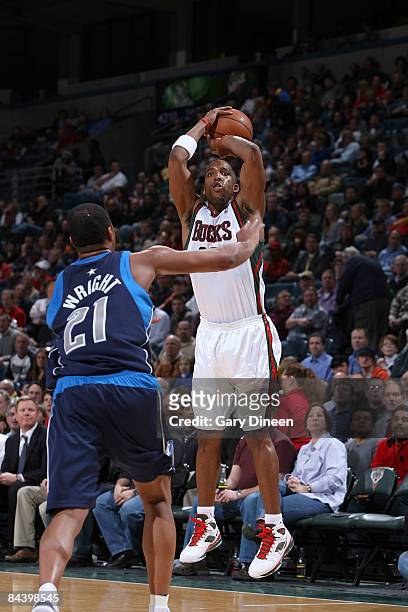 Michael Redd of the Milwaukee Bucks shoots a 3 pointer over Antoine Wright of the Dallas Mavericks on January 21, 2009 at the Bradley Center in...