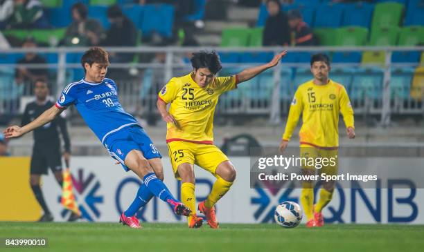 Suwon Samsung FC defender Min Sang Gi fights for the ball with Kashiwa Reysol midfielder Kobayashi Yusuke during the 2015 AFC Champions League Round...